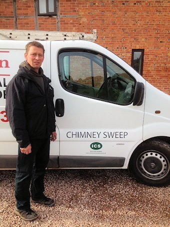 Andy Johnson standing beside his white chimney sweep van